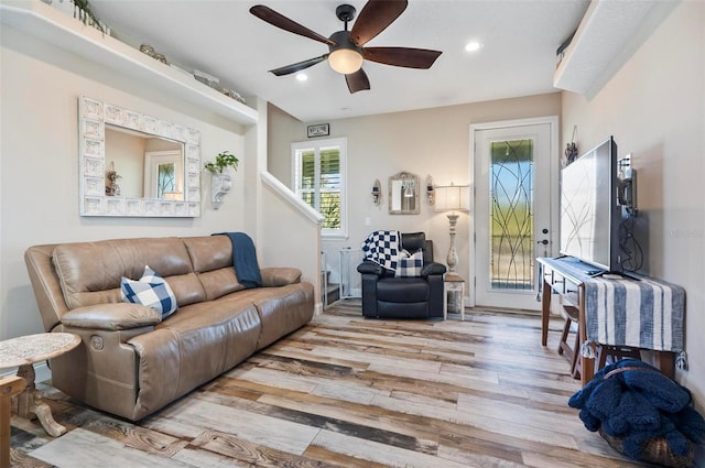 living room featuring ceiling fan and light wood-type flooring