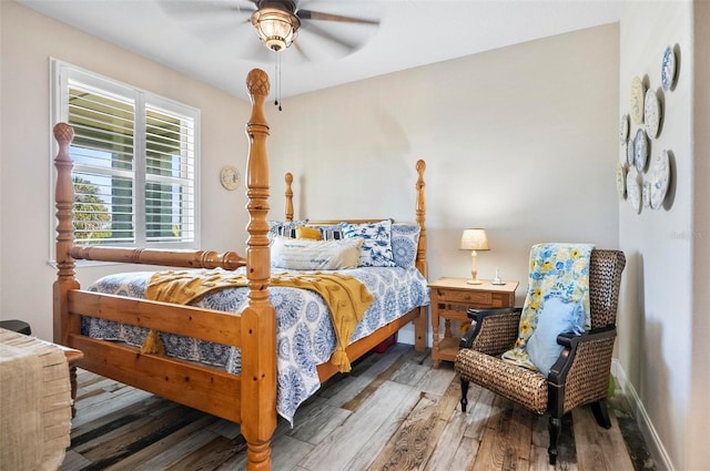 bedroom with dark hardwood / wood-style flooring and ceiling fan