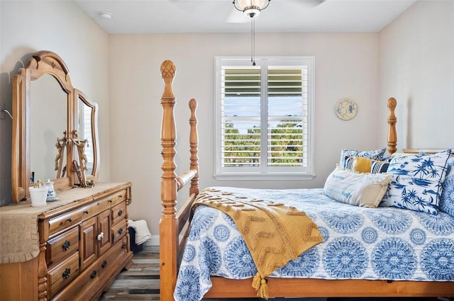 bedroom with dark hardwood / wood-style flooring, multiple windows, and ceiling fan