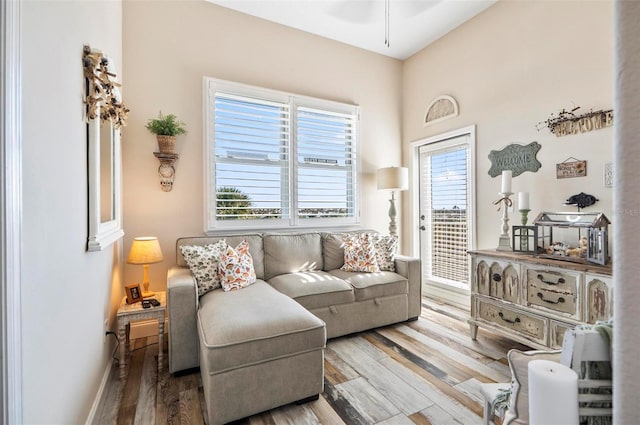 living room with ceiling fan, plenty of natural light, and hardwood / wood-style floors