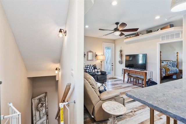 living room with ceiling fan and wood-type flooring