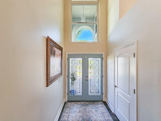 foyer entrance featuring a high ceiling and french doors