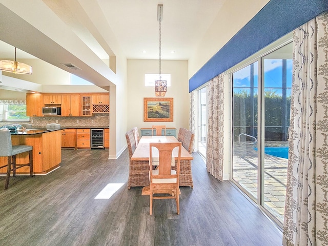 dining space with dark hardwood / wood-style flooring and beverage cooler