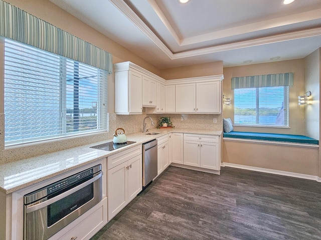 kitchen with white cabinets, light stone countertops, dark wood-type flooring, and appliances with stainless steel finishes