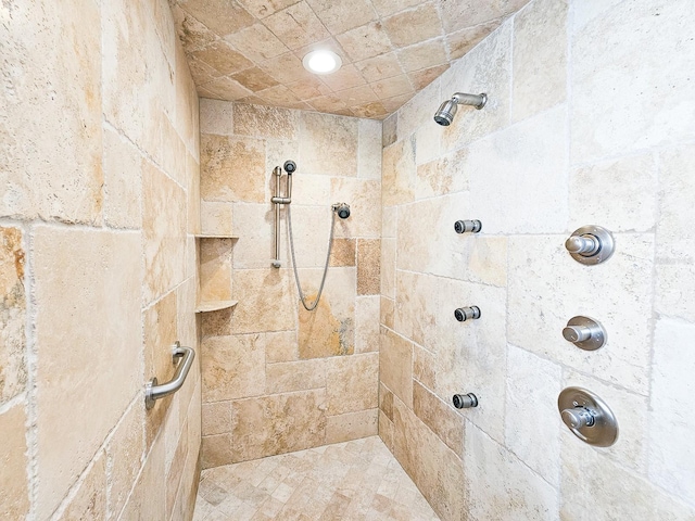 bathroom with tiled shower