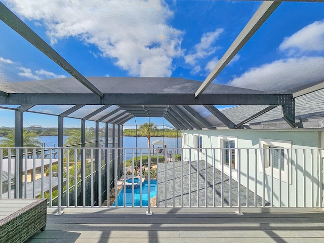 exterior space featuring glass enclosure and a water view