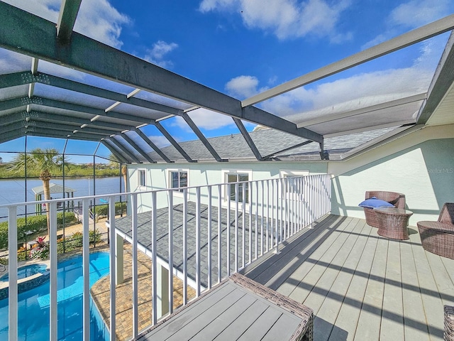 view of swimming pool with a water view and a lanai