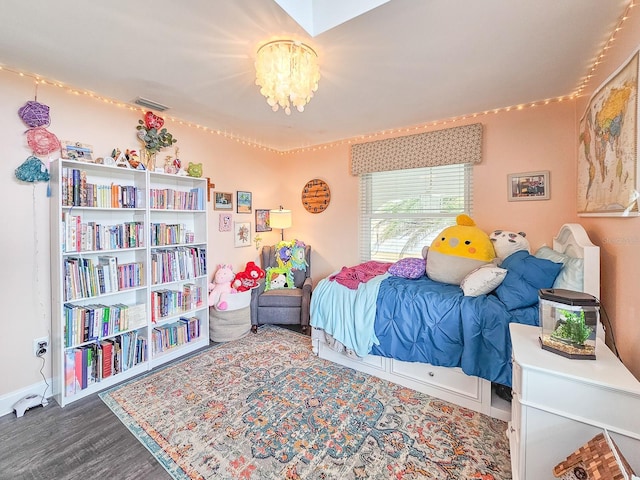 bedroom with a chandelier and hardwood / wood-style flooring