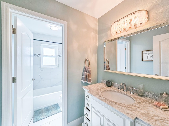 full bathroom with tile patterned flooring, vanity, tiled shower / bath combo, and toilet