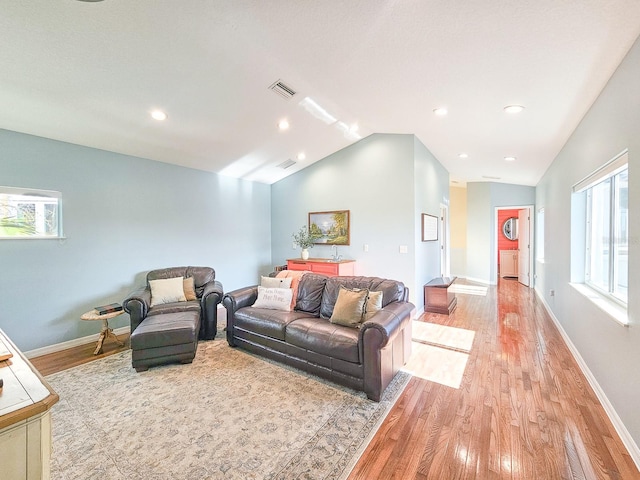 living room with light hardwood / wood-style flooring and lofted ceiling