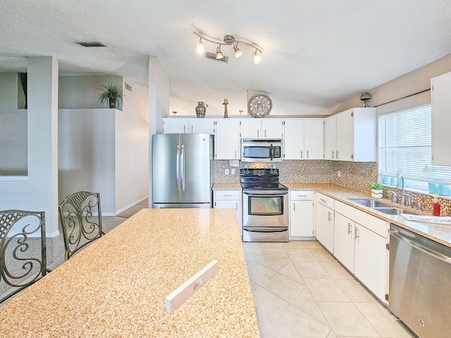 kitchen with sink, a textured ceiling, appliances with stainless steel finishes, and white cabinetry