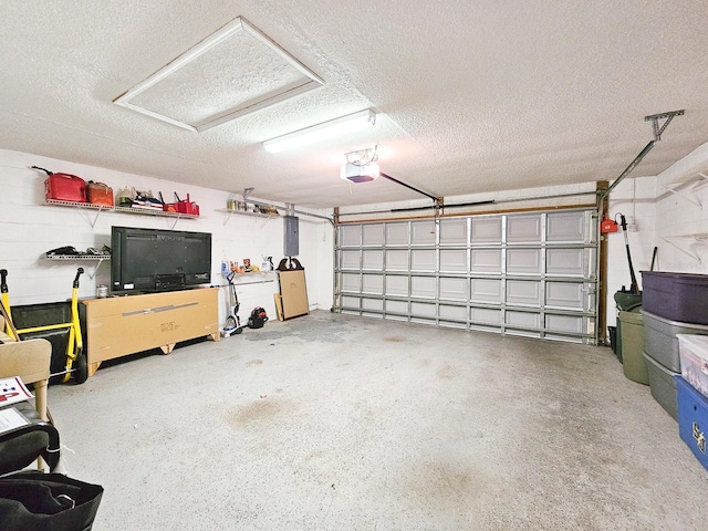 garage with electric panel and a garage door opener