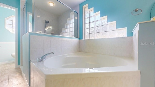 bathroom with tile patterned floors, separate shower and tub, and toilet