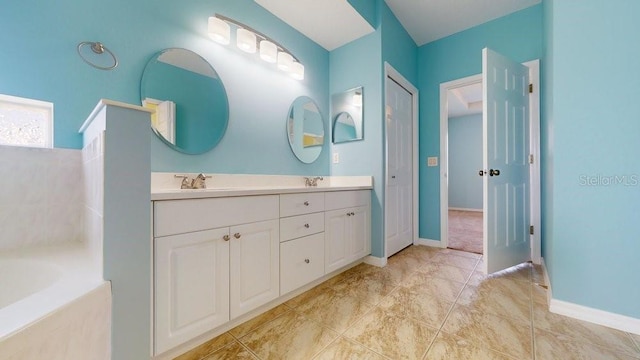 bathroom with a washtub and vanity