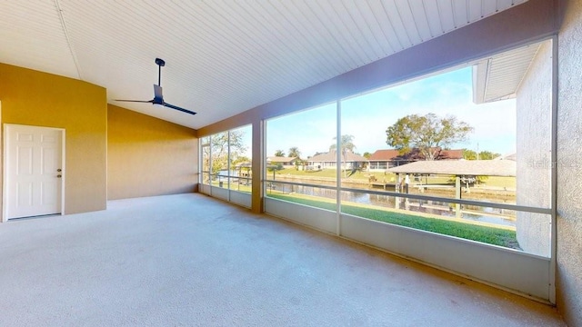 sunroom / solarium with ceiling fan, a water view, and vaulted ceiling