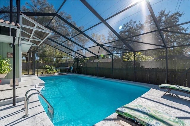 view of pool with a patio and glass enclosure