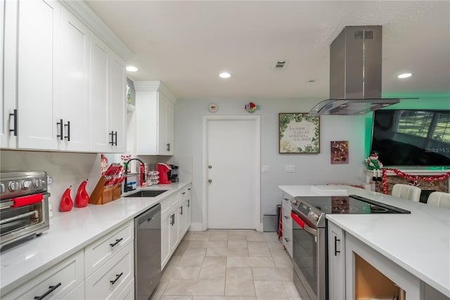 kitchen with white cabinets, appliances with stainless steel finishes, sink, and island range hood