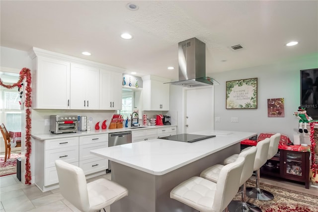 kitchen with sink, white cabinetry, island range hood, a kitchen bar, and black electric cooktop