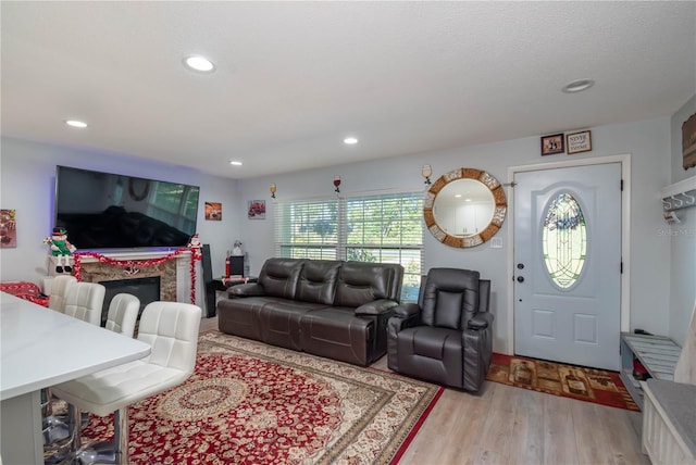 living room with light hardwood / wood-style floors and a textured ceiling