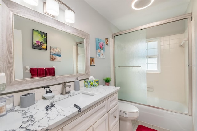 full bathroom with vanity, enclosed tub / shower combo, and toilet