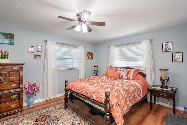 bedroom with wood-type flooring and ceiling fan