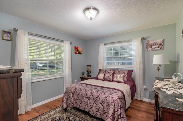 bedroom with hardwood / wood-style flooring and a textured ceiling