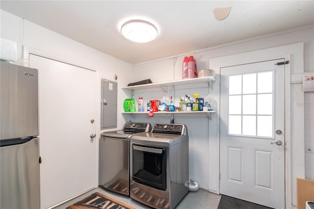 clothes washing area featuring washing machine and clothes dryer and electric panel