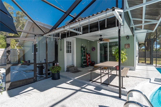 exterior space with ceiling fan and glass enclosure