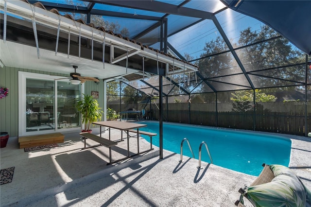 view of pool with ceiling fan, a lanai, and a patio