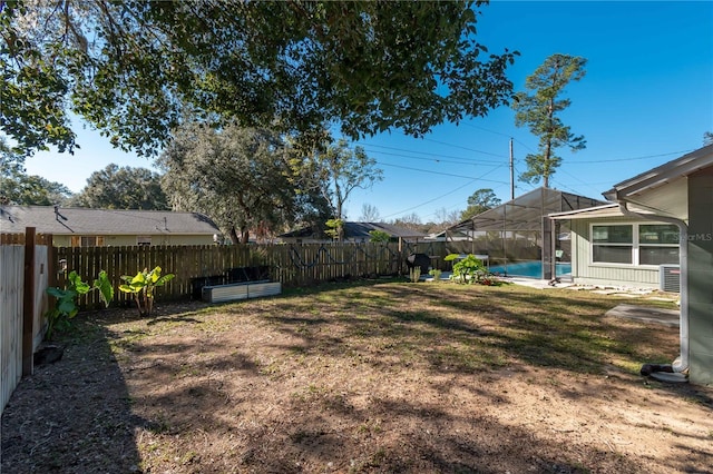 view of yard featuring a fenced in pool and central air condition unit