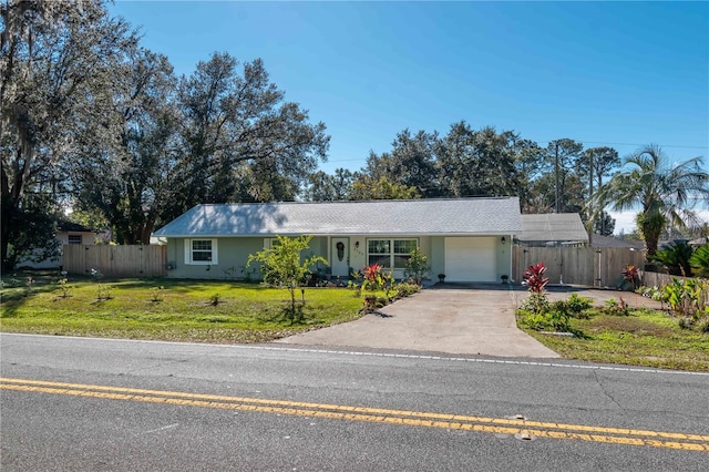 ranch-style home with a garage and a front lawn