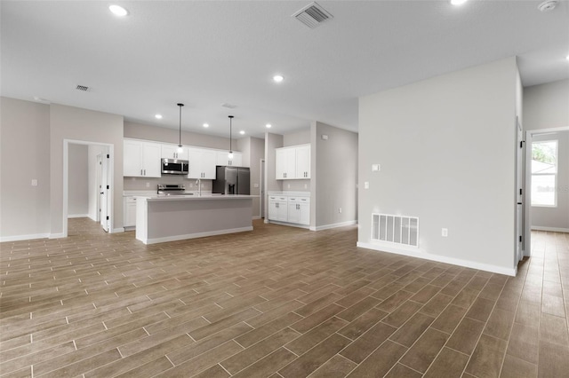 unfurnished living room with light hardwood / wood-style flooring