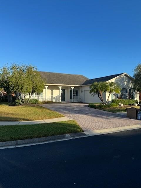 single story home with a front lawn and a garage