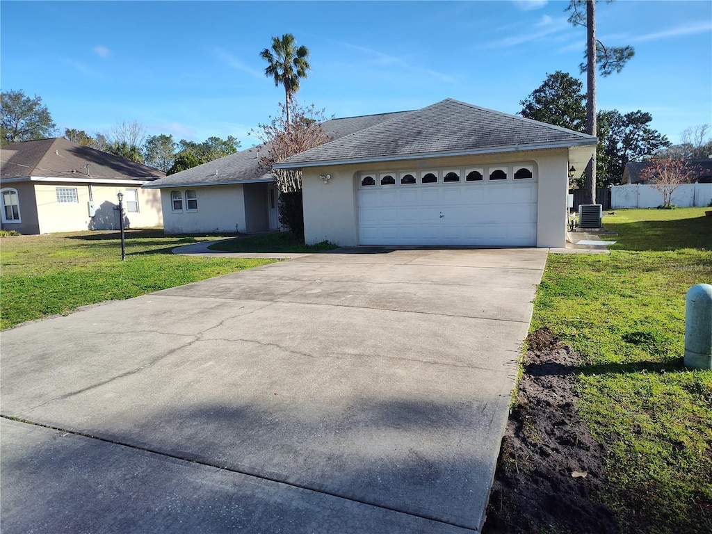 ranch-style house with central AC, a front lawn, and a garage