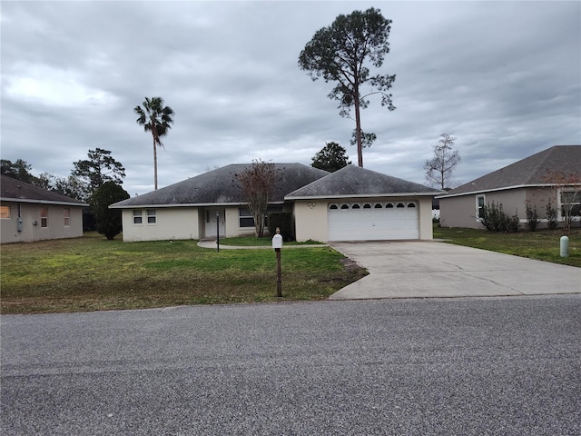 single story home with a front lawn and a garage