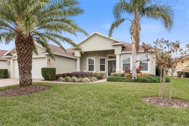 view of front of property with a front yard and a garage