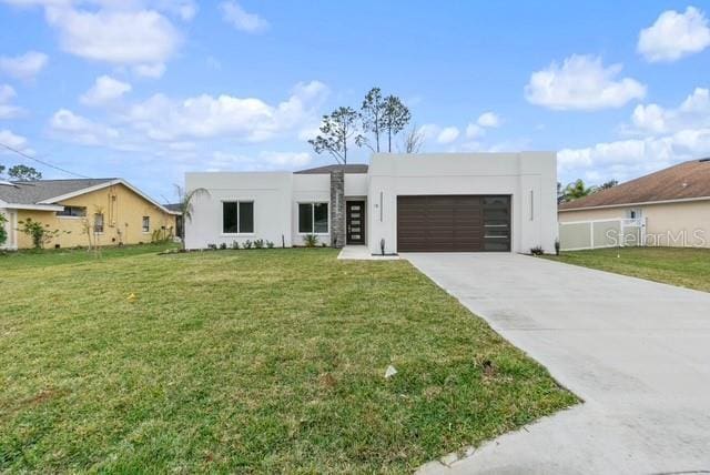 modern home with a garage and a front lawn