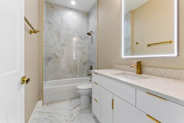 full bathroom featuring vanity, tiled shower / bath combo, and toilet