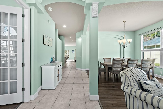 dining room featuring light tile patterned floors and a notable chandelier