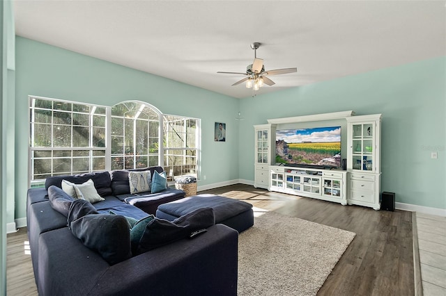 living room with dark hardwood / wood-style flooring and ceiling fan