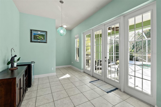 doorway featuring light tile patterned flooring and french doors