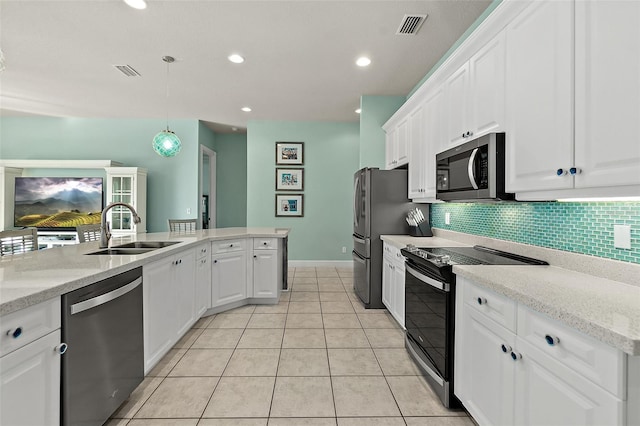 kitchen with stainless steel appliances, sink, pendant lighting, light tile patterned floors, and white cabinets