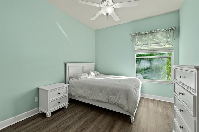 bedroom with dark hardwood / wood-style flooring and ceiling fan