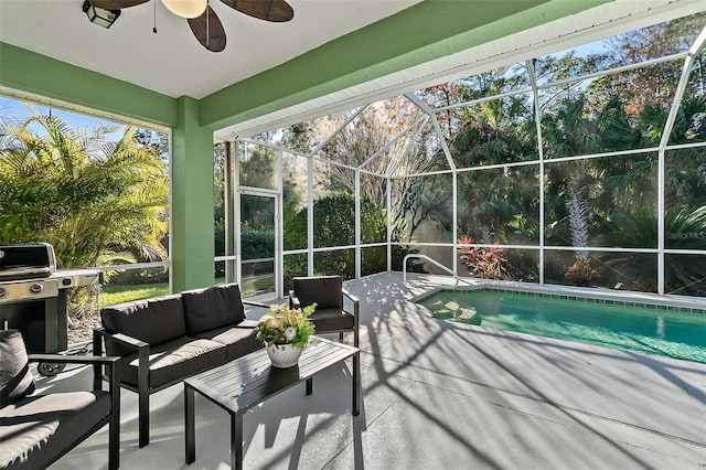 view of pool with glass enclosure, ceiling fan, a grill, an outdoor hangout area, and a patio area