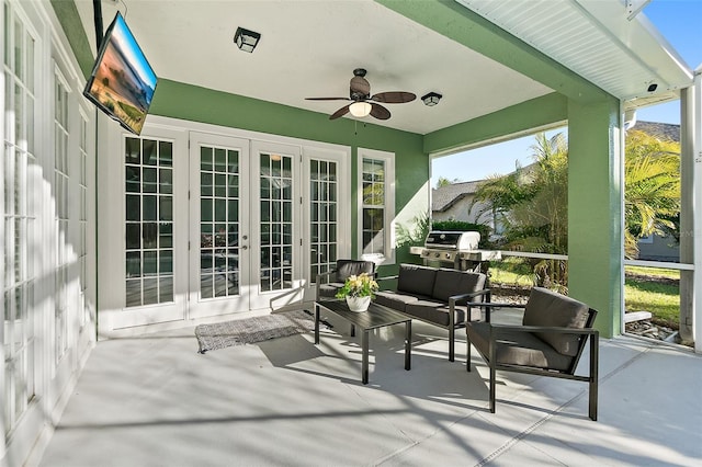 sunroom with ceiling fan, a wealth of natural light, and french doors