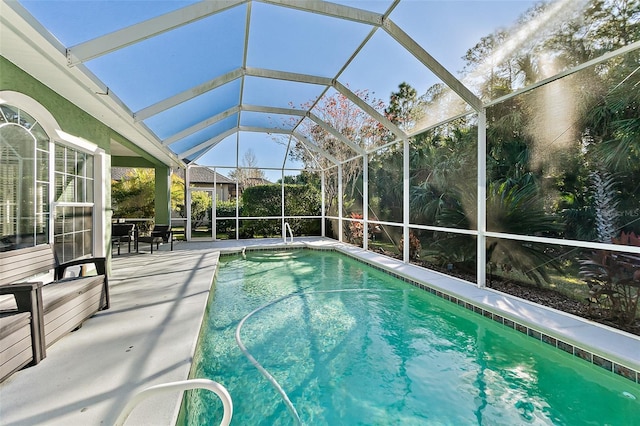 view of swimming pool with glass enclosure