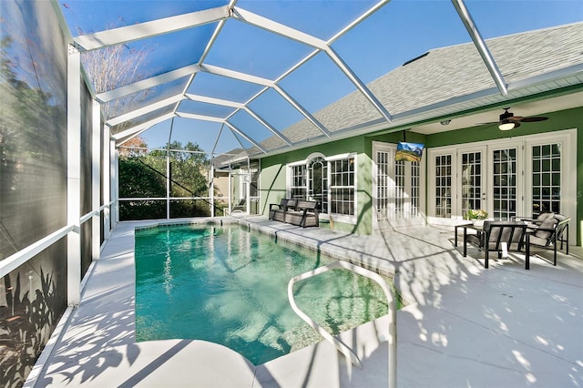 view of pool with ceiling fan, a patio, glass enclosure, and french doors