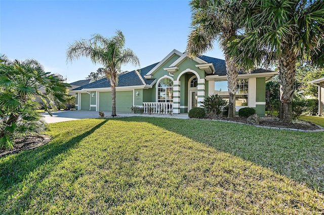 ranch-style house with a front yard and a garage