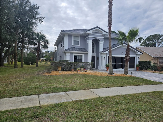 view of front of house with a garage and a front lawn