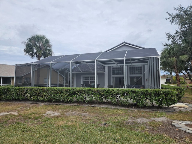 rear view of property featuring glass enclosure